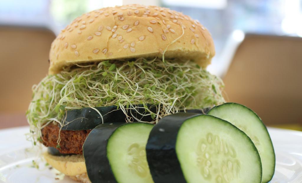 Eat Your Veggies · Cooked brown rice, black beans, alfalfa sprouts, cucumbers, hummus spread, and wheat bun.