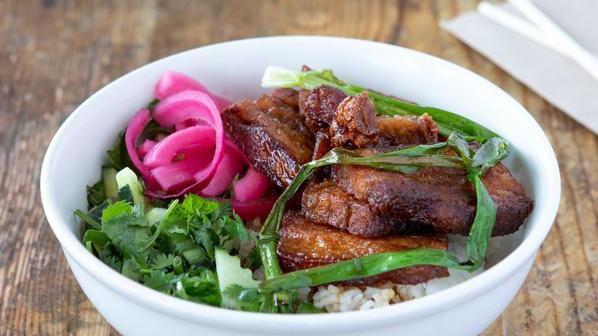 Pork Belly Bowl · Tender pork belly glazed with sweet spicy soy and fermented bean glaze with grilled scallions and pickles over jasmine rice. Served with cucumber,cilantro and mint.This item contains gluten.