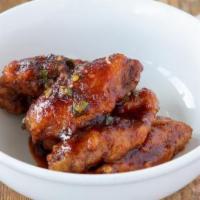 Wings · Crispy, sticky and spicy. Glazed with a fish sauce caramel spiced with a red curry paste, le...