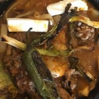 Molcajete · Steak, prawns, chicken, rice, beans, cheese, mushrooms, cactus, sauce and your choice of cor...