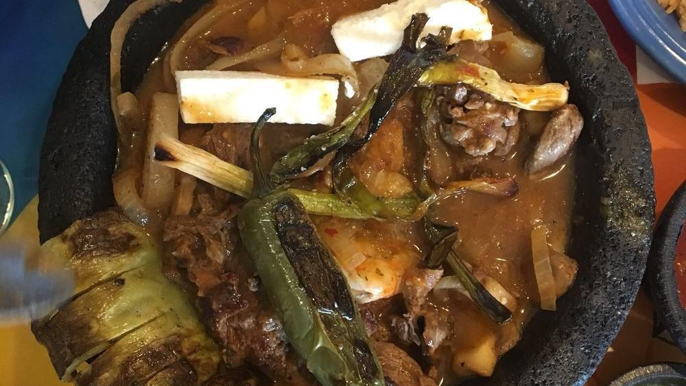 Molcajete · Steak, prawns, chicken, rice, beans, cheese, mushrooms, cactus, sauce and your choice of corn or flour tortillas.