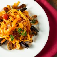 Fettuccine Pescatore · Fettuccine in a tomato sauce with prawns, calamari, mussels and clams.
