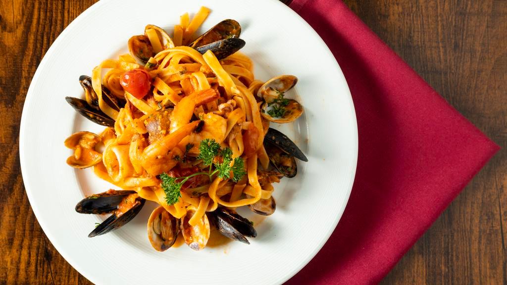 Fettuccine Pescatore · Fettuccine in a tomato sauce with prawns, calamari, mussels and clams.