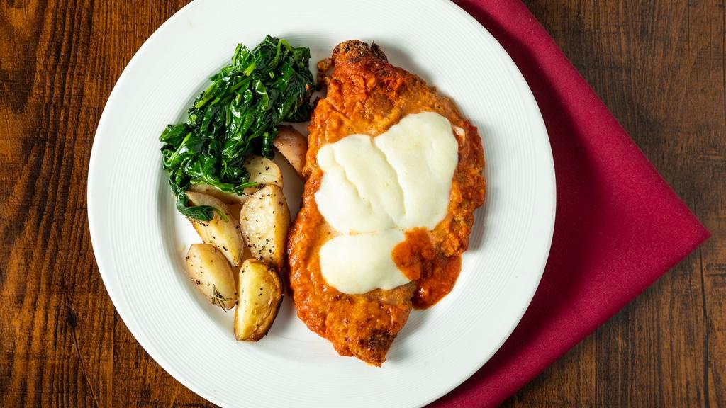 Chicken Parmigiana · Breaded and baked chicken in a tomato sauce with fresh mozzarella. Served with roasted potatoes and sauteed spinach.
