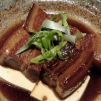 104. Buta Kakuni · Japanese style stewed pork belly, tofu and green onion with sweet soy base sauce.