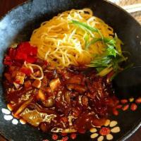 610. Ja Ja Ramen · Spicy. Noodles on a plate topped with spicy and sweet shredded pork, mushroom, onion, and gr...
