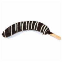 Chocolate Dipped Banana · Whole frozen banana dipped in dark chocolate and decorated with your choice of white chocola...