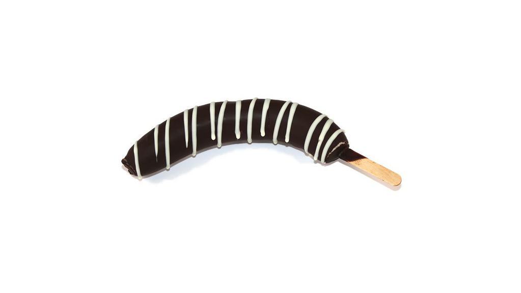 Chocolate Dipped Banana · Whole frozen banana dipped in dark chocolate and decorated with your choice of white chocolate drizzle, chopped almonds, or rainbow sprinkles served on a popsicle stick.