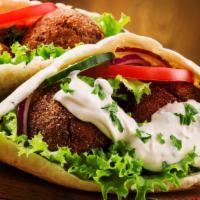 Falafel Sandwich · Meatless sandwich made from deep-fried grounded chickpeas mixed with spices. Served in Fresh...