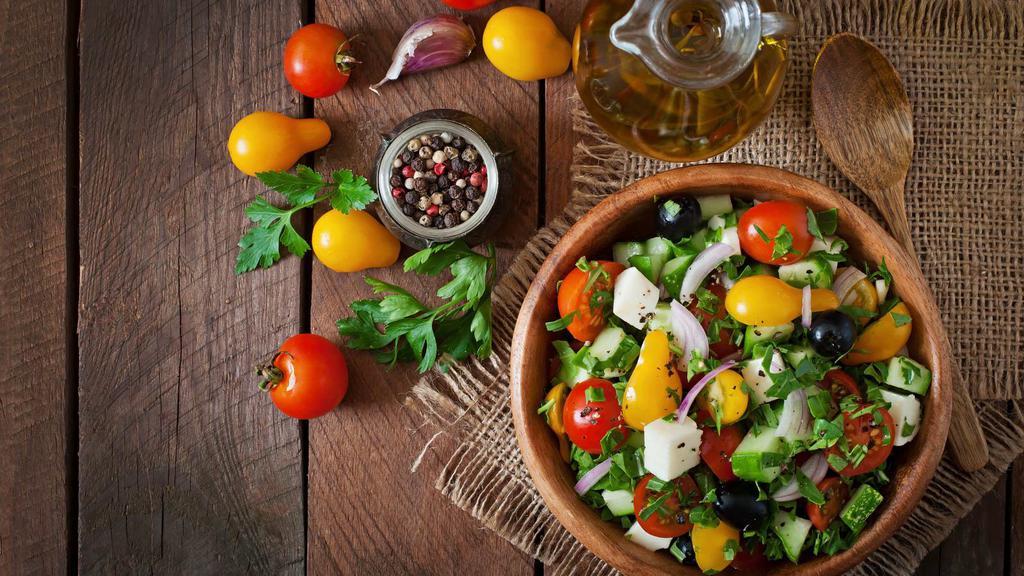The Greek Salad · Fresh salad made with shredded lettuce, sliced tomatoes, onions, bell peppers, cucumber, pepperoncini, kalamata olives, and feta cheese with a choice of dressing.