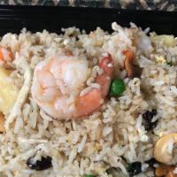 #65. Pineapple Fried Rice · Pineapple fried rice with egg, cashews, raisins, chicken, shrimp, peas and carrots.