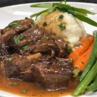 Stout Braised Roast · Green beans, smashed red potatoes, baby carrots & braising sauce