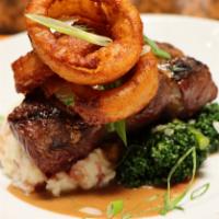 Prime Flat Iron · Smashed red potatoes, broccolini, whiskey-peppercorn sauce & battered onion ring
