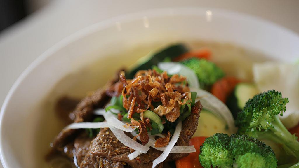 Soy Beef Pho (Vegan) · Vegan, gluten-free. No meat product. Aromatic vegetable broth topped with tofu, broccoli, carrots, mushrooms, zucchini, cabbage, and crispy fried onions (beef broth or chicken broth on request.
