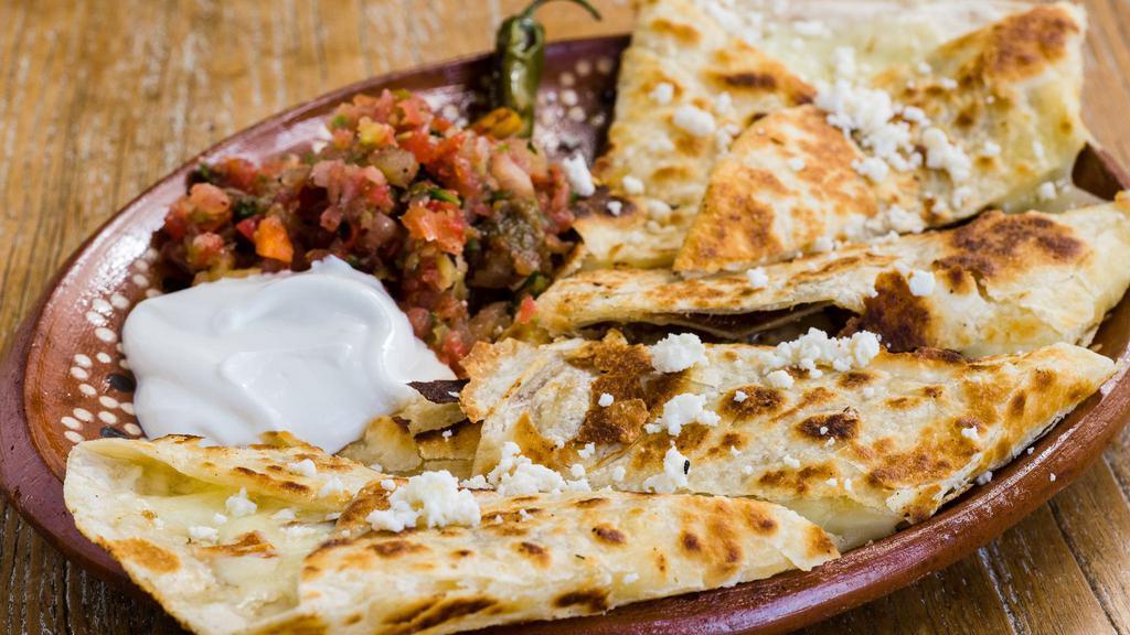 Quesadilla La Mission · Flour tortilla filled with cheese, crema and served with salsa fresca