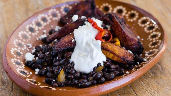 Platanos · Fried sweet plantains, Oaxaca refried beans, chipotle crema and queso
