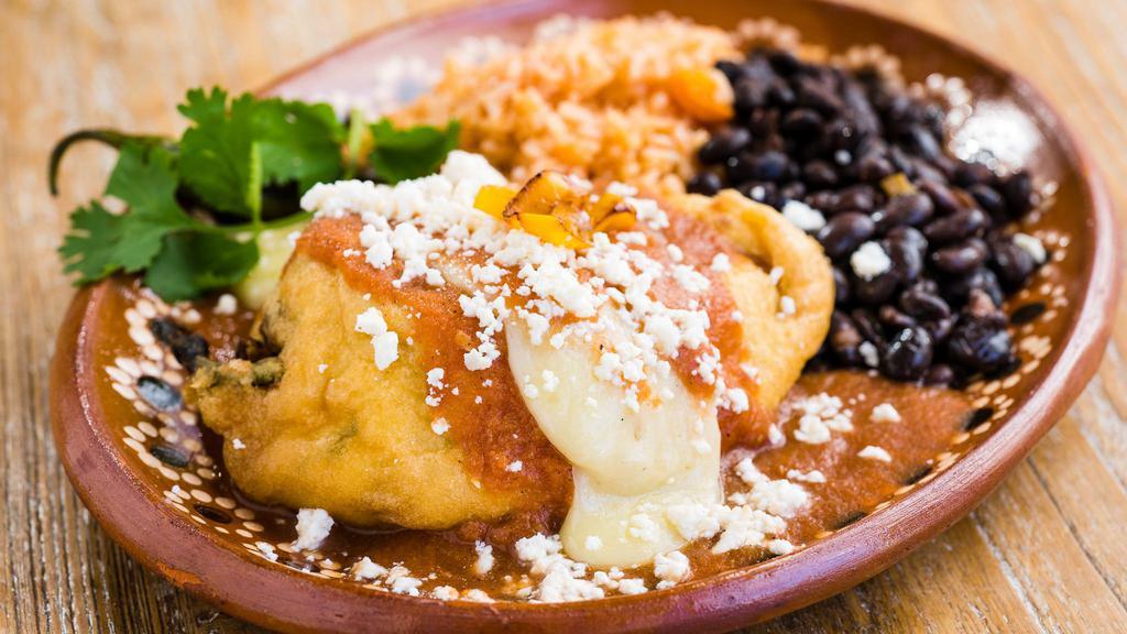 Chile Relleno · Pasilla chile, stuffed with queso, topped with ranchera sauce