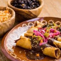Flautas de Mole · Mole Poblano crispy roll taquitos with pickle onion, jalapeños and ajonjoli