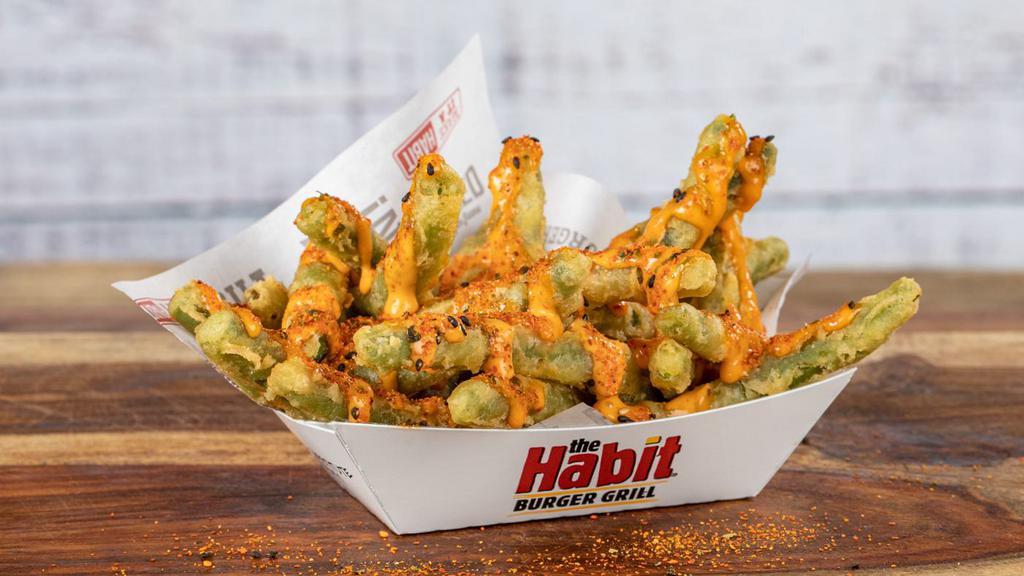 Spicy Green Beans · Golden crisp tempura battered green beans are drizzled with house-made creamy sriracha lime aioli, then
seasoned with a touch of 7-Spice pepper blend.