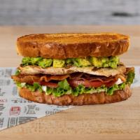 Chicken Club Sandwich · Grilled chicken breast, fresh green leaf, and tomato, crisp bacon, avocado and mayo served o...