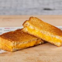 Grilled Cheese · Two slices of American cheese between two buttered slices of grilled, sourdough bread.