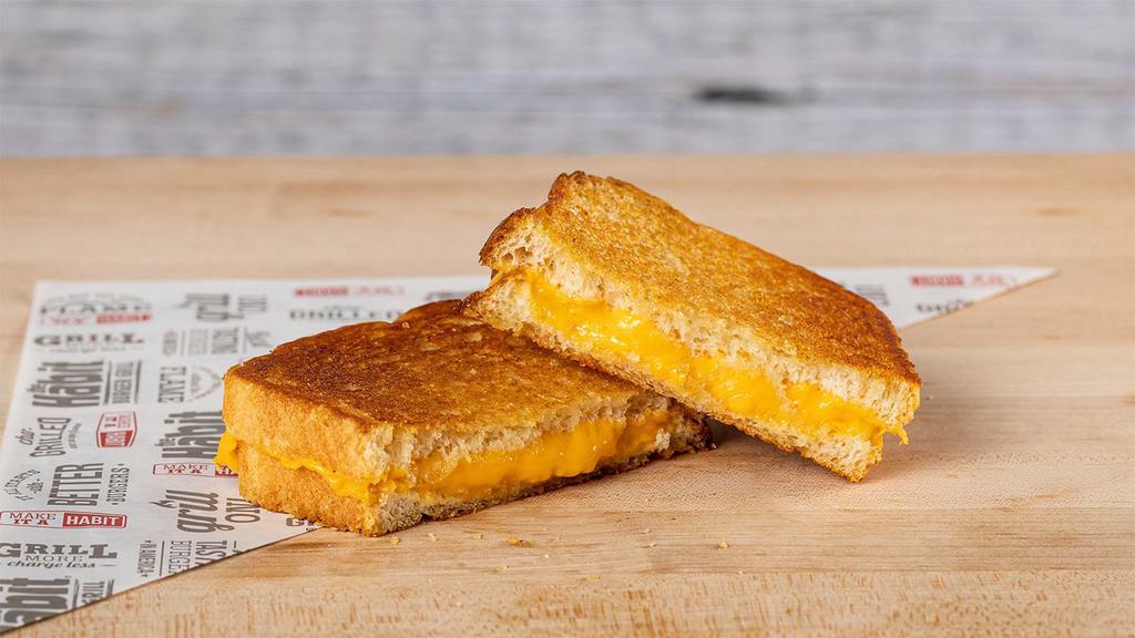 Grilled Cheese · Three slices of American cheese between two buttered slices of grilled sourdough bread