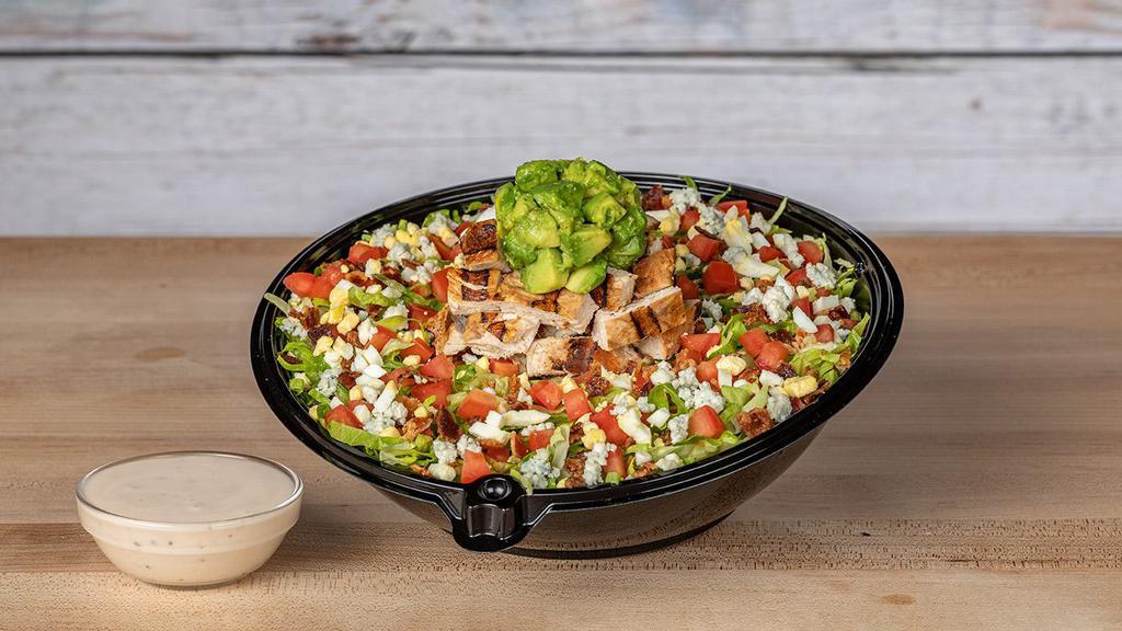 Santa Barbara Cobb · Crisp shredded iceberg and Romaine lettuce, diced tomatoes, avocado, blue cheese crumbles, hickory-smoked bacon, and egg, tossed in our red wine vinaigrette, topped with chargrilled chicken breast