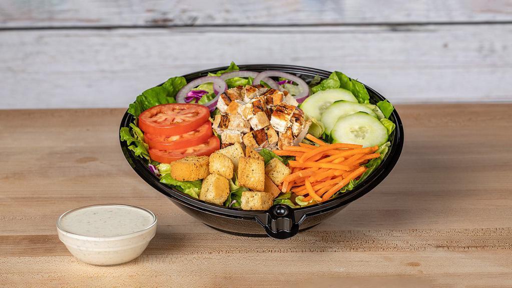 Grilled Chicken Salad · Romaine, iceberg, green and red leaf lettuce, red cabbage, Roma tomatoes, cucumbers, red onions, carrots and croutons, topped with a chargrilled chicken breast.