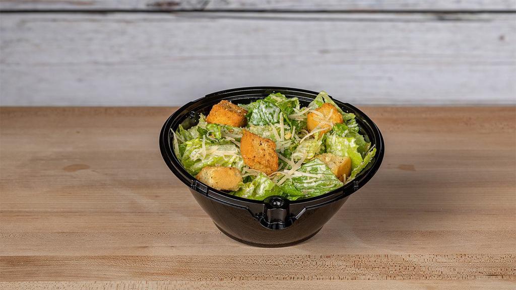 Side Caesar Salad · Chopped Romaine tossed in our Caesar dressing, croutons and fresh Parmesan.