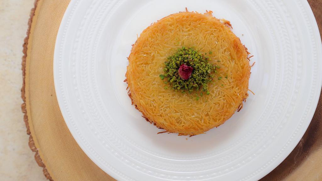 Knafeh Creme · Shredded filo dough (knafeh) mixed with butter, filled with unsweetened milk custard, baked to perfection. Drizzled with orange blossom sugar syrup.