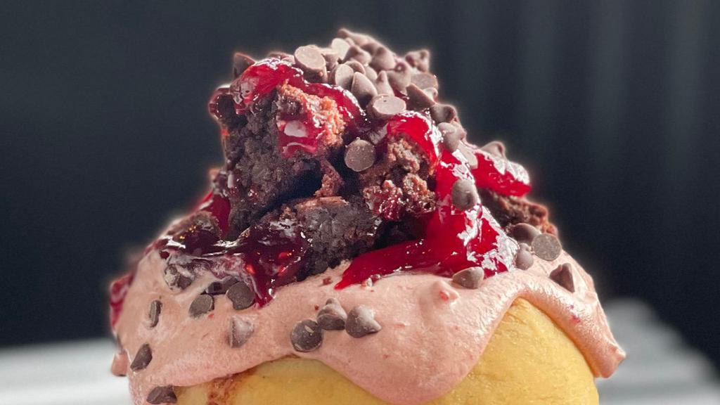 Razzle Dazzle Roll 
 · decadent chocolate raspberry frosting topped with homemade brownie bites, chocolate chips, and raspberry jam