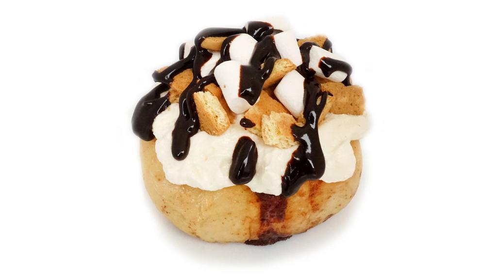 Campfire S'mores Roll · marshmallow frosting topped with marshmallows, graham cookies and chocolate sauce