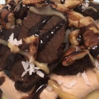 German Chocolate Roll · chocolate frosting topped with brownie bites, pecans, coconut, caramel sauce and chocolate s...