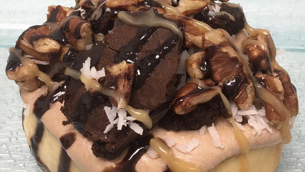German Chocolate Roll · chocolate frosting topped with brownie bites, pecans, coconut, caramel sauce and chocolate sauce