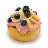 Tropical Bliss · Raspberry frosting topped with fresh bananas, blueberries, and coconut.