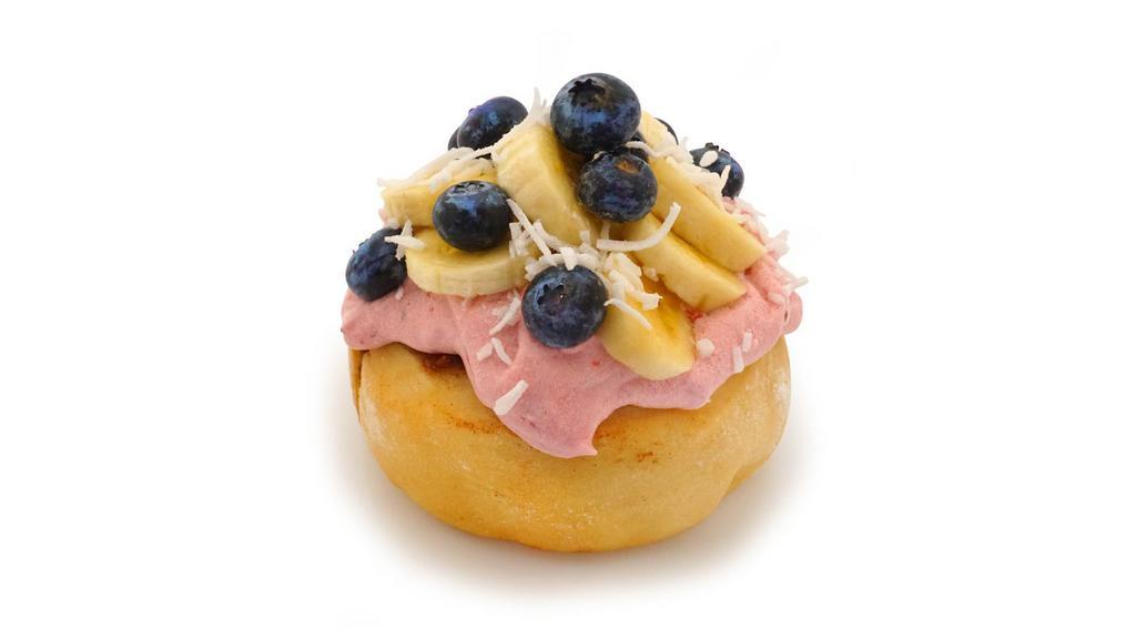 Tropical Bliss Roll · raspberry frosting topped with fresh bananas, blueberries and coconut
