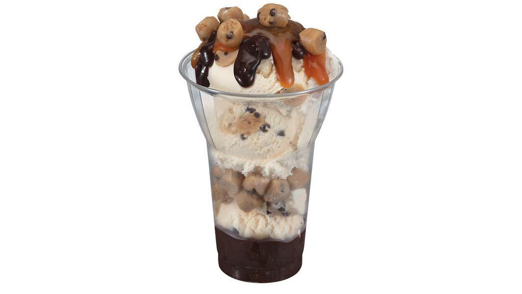Chocolate Chip Cookie Dough Layered Sundae · Three scoops of Chocolate Chip Cookie Dough Ice Cream with layers of hot fudge and cookie dough pieces, topped with caramel. Delivered products will not include whipped cream.