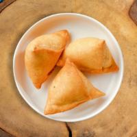 Samosas · Assorted vegetables dipped in a light batter and fried until golden brown. Served with our s...