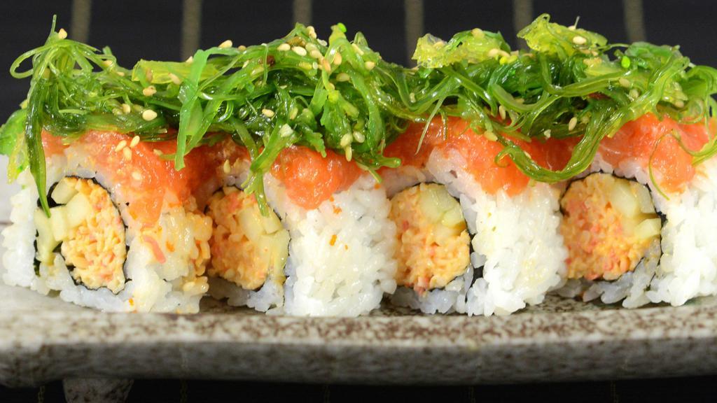 Aloha Roll · spicy crab meat and cucumber topped with spicy salmon and seaweed salad.