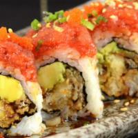 Ichiban Roll · Soft shell crab and avocado topped with spicy tuna, tobiko, and eel sauce.