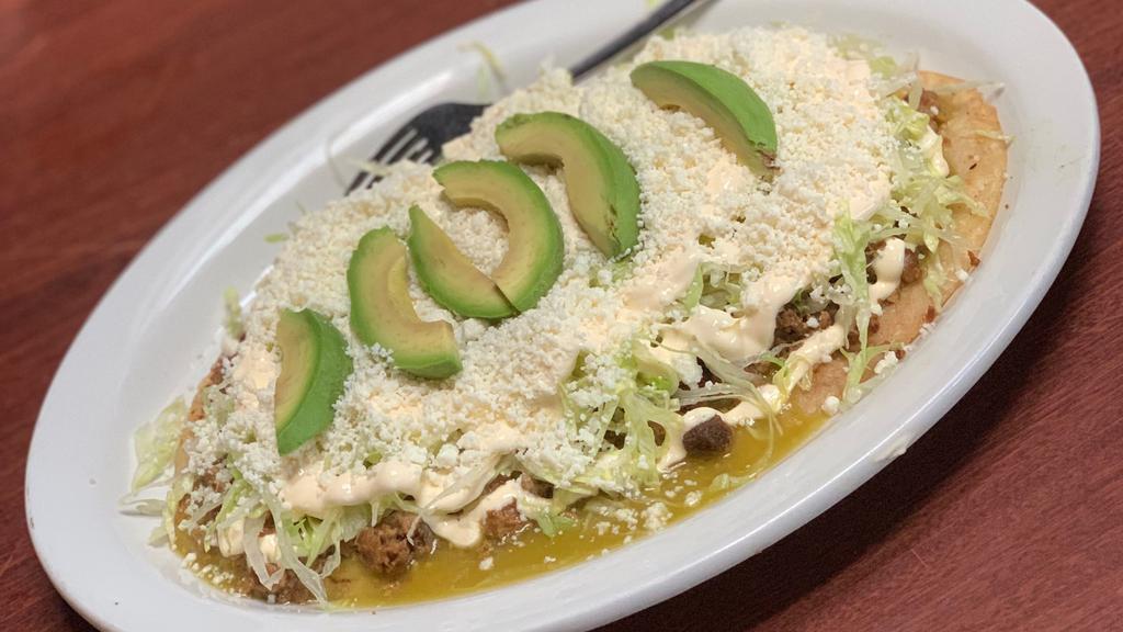 Huarache · with choice of meat, salsa verde, lettuce and cheese

Please request sour cream and avocado on coments