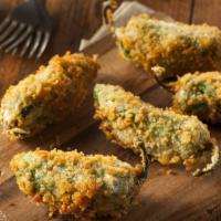 Jalapeño Poppers · Golden deep-fried jalapeños filled with cream cheese.