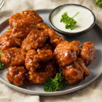 Boneless Halal BBQ Fried Wings · Halal! Batch of crispy breaded wings tossed in sweet BBQ sauce.