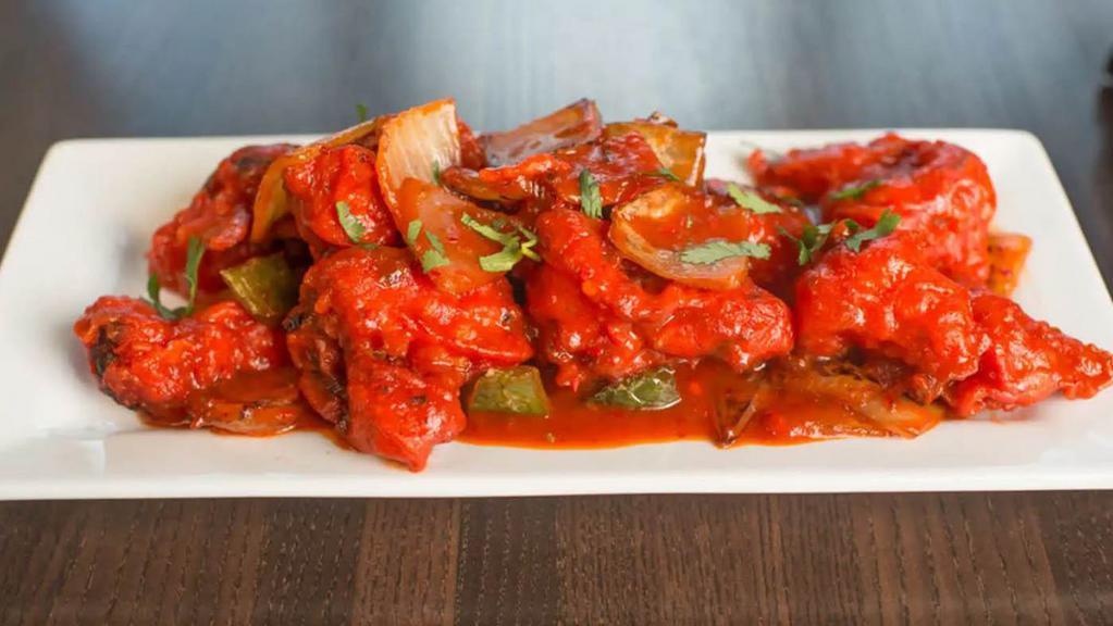 Chilli Fish · Boneless pieces of fish, batter fried and doused in a spicy-tangy sauce made with soy, tomato and chilli sauce along with chillies, ginger and garlic.