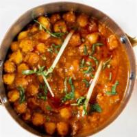 Chana Masala · Tender chick peas prepared in a flavor curry infused with locally grown ginger, garlic, and ...