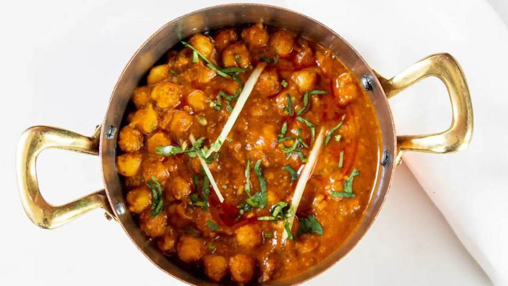 Chana Masala · Tender chick peas prepared in a flavor curry infused with locally grown ginger, garlic, and coriander.