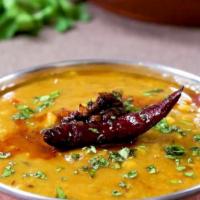 Yellow Tadka Daal · A classic dish made with the combination of yellow lentils and tomatoes tempered with mustar...