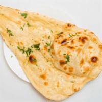 Butter Naan · Hand stretched naan baked in tandoor oven and brush with butter once done.