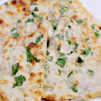 Kulchha · Naan stuffed with choice of onion/paneer/potato with indian spices and baked in oven.