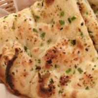 Garlic & Chilli Naan · Hamemade naan topped with green chilli and baked on indian clay oven.